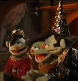 Three Elvis-style Muppets dressed in medieval clothing, the one on the left with a crown and the one on the right with a wizard's hat
