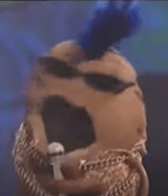 Potato Muppet with a blue mohawk, sunglasses, microphone, and chains