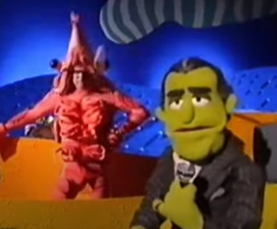 Left background: Pierce Brosnan in a prawn costume. Right foreground: Johnny Fiama with a microphone.