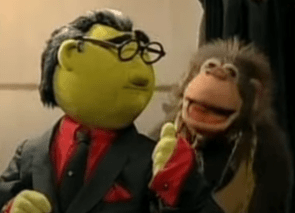 Left: Bunsen Honeydew in black suit, red shirt, and black-and-gray toupee, giving a thumbs up. Right: Sal.